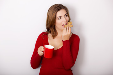 Woman drinking coffee with cookies