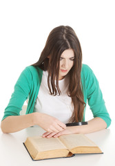 Young beautiful student sitting with book, reading, learning.