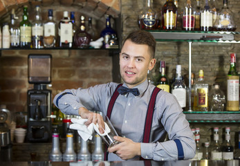 young man working as a bartender in a nightclub bar