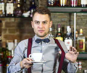 young man working as a bartender in a nightclub bar