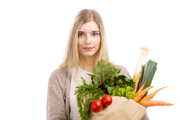 Beautiful woman carrying vegetables