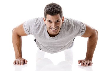 Handsome young man making pushups - obrazy, fototapety, plakaty