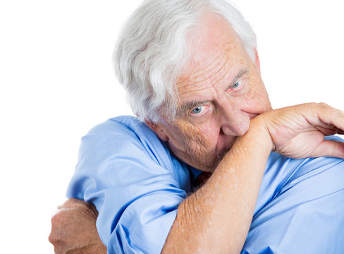 Stressed, anxious, scared old man biting his arm