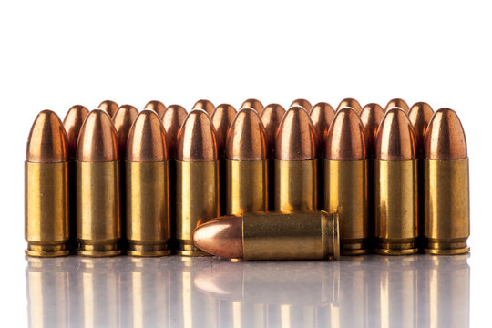 A group of 9mm bullets for a a gun isolated on white