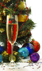 glass of champagne, candles and Christmas tree