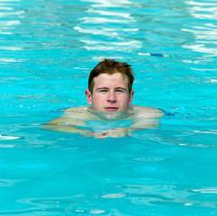 boy has fun swimming in the pool