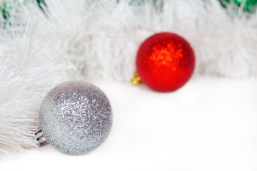 Silvery and red balls and white Christmas tinsel