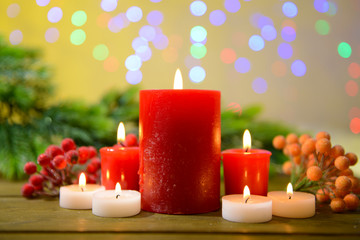 Candles and Christmas decoration on bright background