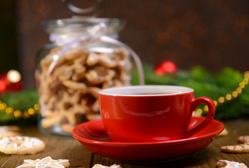 Delicious Christmas cookies in jar on table on brown background