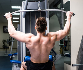 Fototapeta premium bodybuilder with simulator