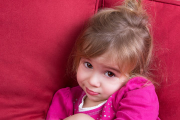 Shy little girl looking at the camera