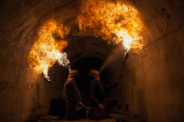 Young man blowing fire from his mouth