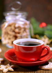Delicious Christmas cookies in jar on table on brown background