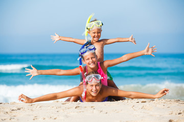 three happy children on beach...