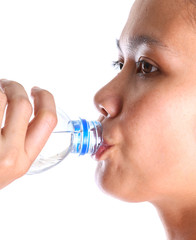 Female drinking mineral water over white background