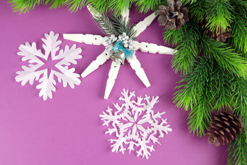 Beautiful snowflakes with fir branch on purple background