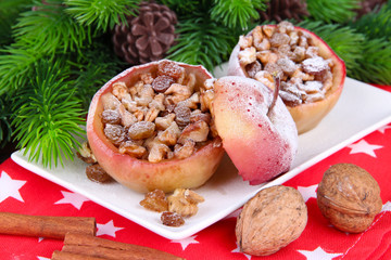 Naklejka na ściany i meble Baked Christmas apples with nuts and raisins on table close up