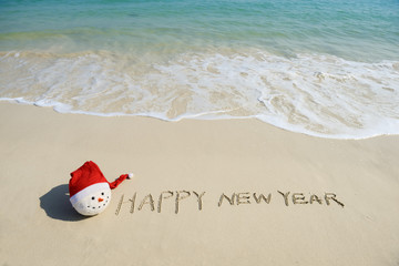 happy new year message on the sand beach