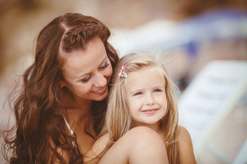 Happy family resting at beach in summer