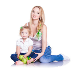 Fototapeta na wymiar portrait of young mother and little daughter with apples
