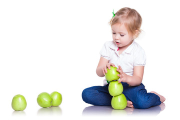 Fototapeta na wymiar Adorable little girl sitting with green apples