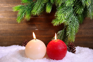 Burning candles on wooden background