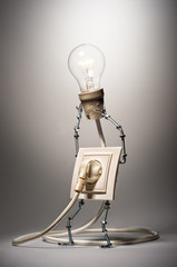 Rosette holding aloft a glowing light bulb