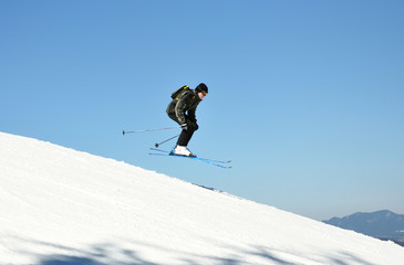 Jumping skier in the mountains