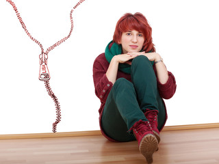 Young woman sitting relaxed on the floor