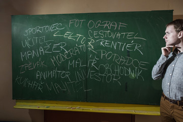man at the blackboard writes various professions