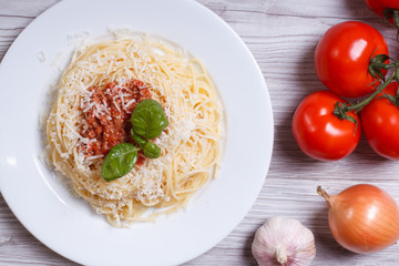 Spaghetti with bolognese sauce and ingredients. top view