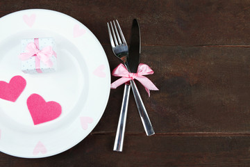 Romantic holiday table setting, on wooden background