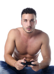 Fototapeta premium Handsome young man shirtless playing videogames with joypad