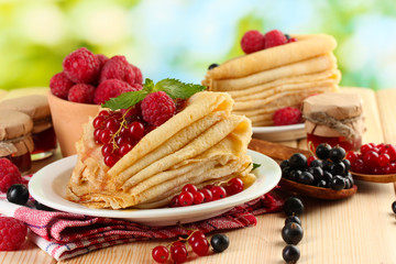 pancakes with berries, jam and honey