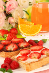 Delicious toast with strawberry on table close-up