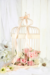 Fototapeta na wymiar Beautiful decorative cage with beautiful flowers