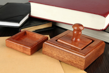 Wooden stamp with notepads  and books on table