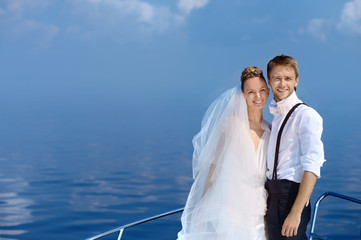 Happy bride and groom on a yacht