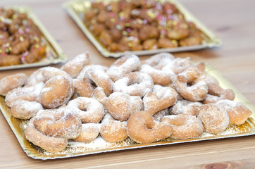 Tray with sugary donuts with pestiños background