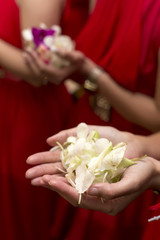 Hand of bridesmaids holding flower