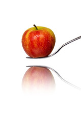 an red apple on a fork with reflection, isolated on white