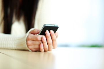 Closeup image on a female hands holding smartphone