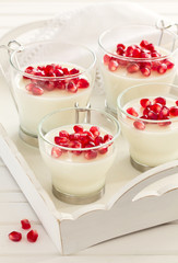Creamy panna cotta with pomegranate seeds.