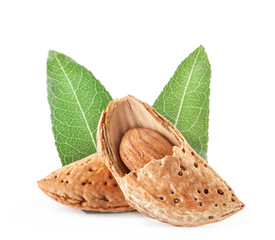Group of almond nuts with leaves. Isolated on white