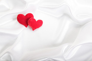 Red hearts on pearls background