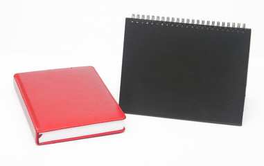 notebook and blank calendar on white background.