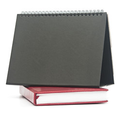 notebook and blank calendar on white background.