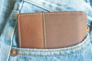 Brown wallet in jeans trousers back pocket