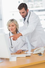 Doctors using computer at medical office