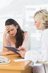 Female doctor discussing reports with patient